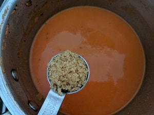 Adding sugar to balance the tartness of tomatoes