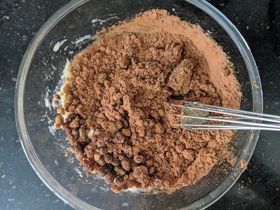 Cocoa powder and jaggery added to the mashed over ripe bananas