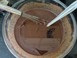 Adding vanilla and oil to the chocolate