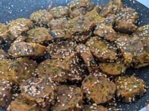 muthiya tossed in tempering of mustard and sesame seeds.