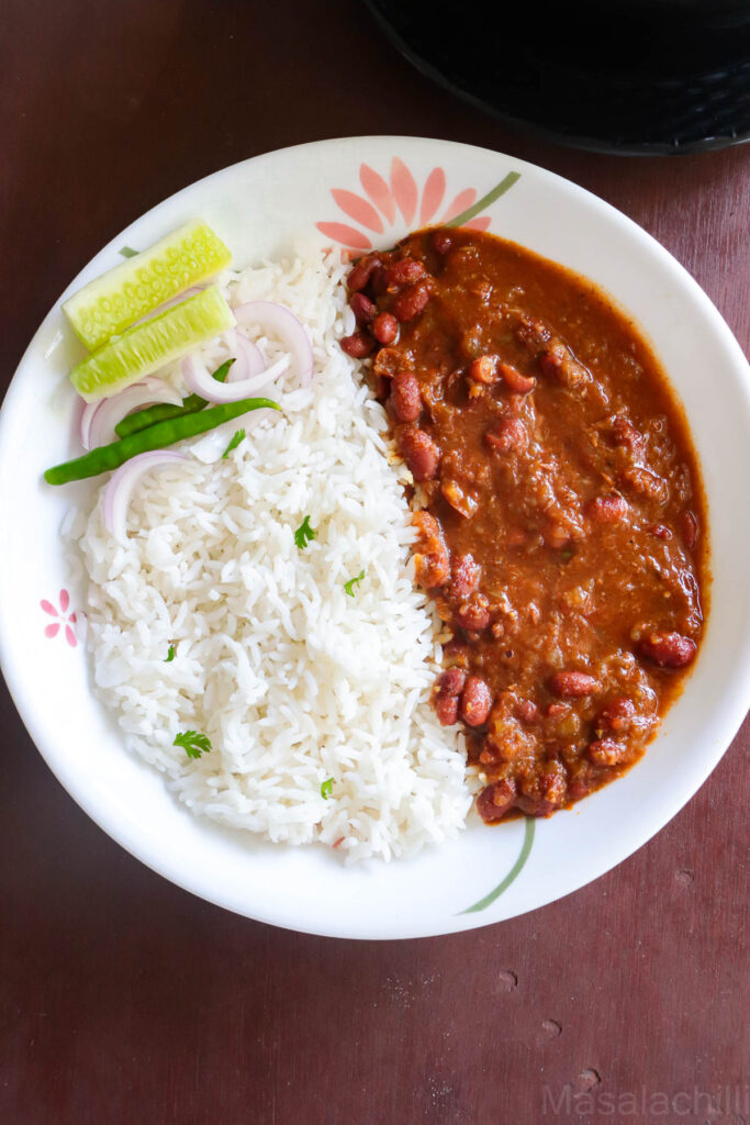 Lunch served with steamed rice, salad and Rajma masala