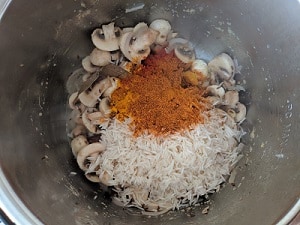 Biryani Masala and spices added to the rice and mushrooms