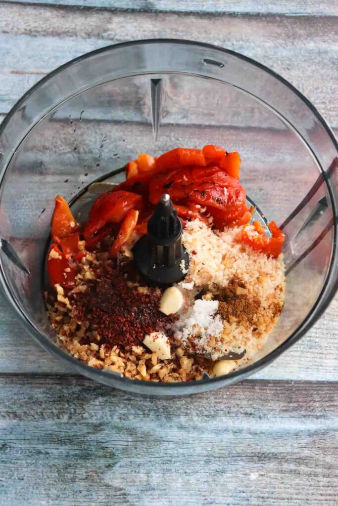 Food Processor jar with all the ingredients for Muhammara