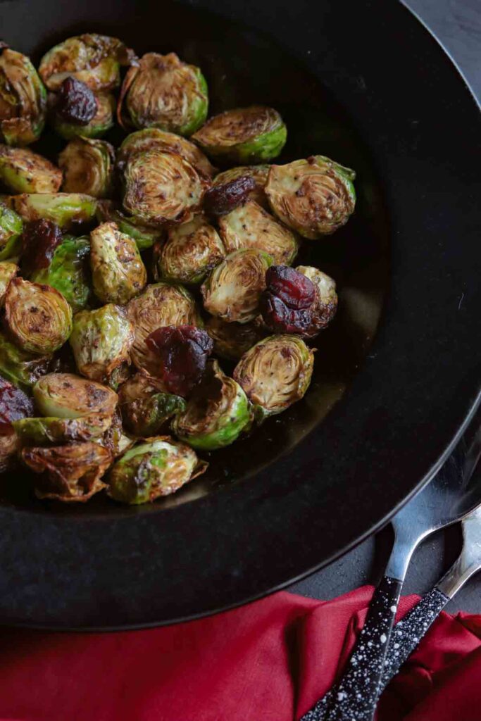 Close up image of brussels sprouts roasted and topped with cranberries