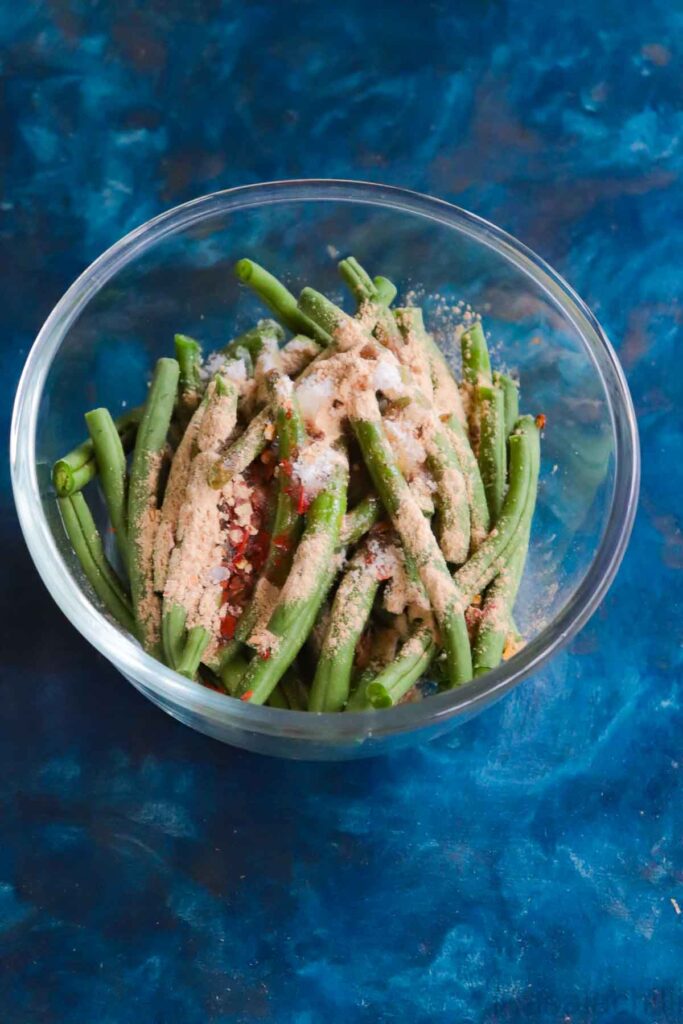 Glass bowl with string beans, spices and seasoning