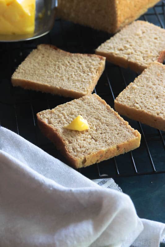 Slices of Whole Wheat Bread with a knob of butter placed on a wire rack