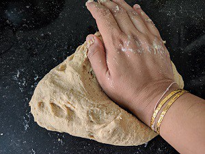 kneading the dough using hands