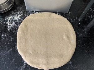 shaping the loaf using the bread tin as measurement