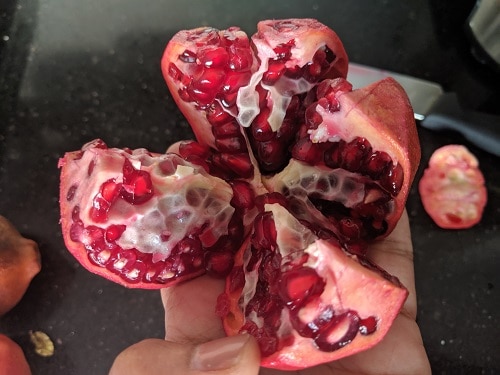 Cutting the pomegranate fruit