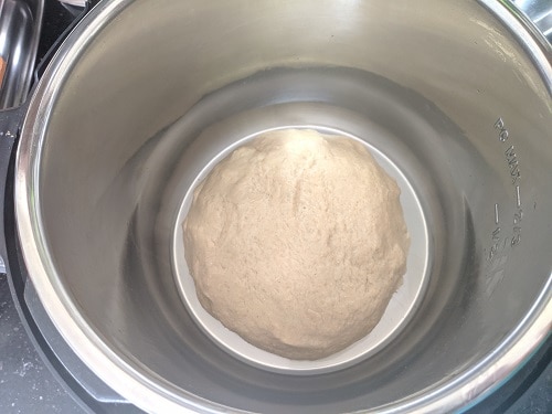 Placing the kneaded dough, cover with lid