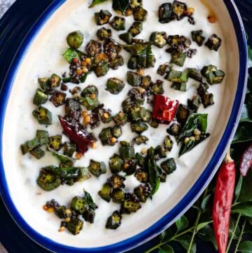Kerala Style Vendakkai Thayir Pachadi Recipe served on a blue plate in a bowl with blue rim