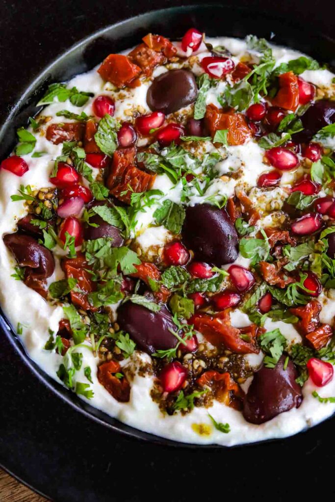 Labneh dip topped with kalamata olives, sun dried tomatoes, herbs and zaatar