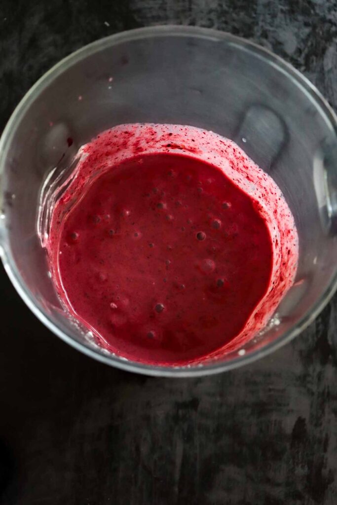 Mixed berries, banana and yogurt blitzed together in a blender jar