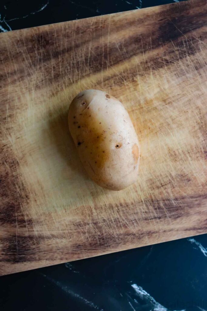 Potato placed on a cutting board