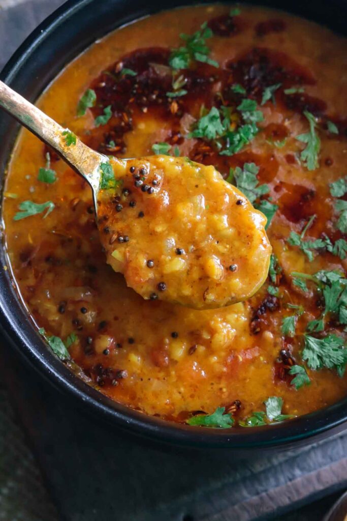 Spoonful of dal tadka tempered with mustard leaves and cumin