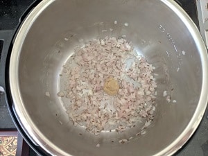 sautéing finely chopped onions, ginger garlic paste with cumin