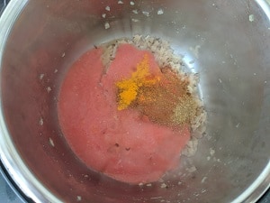 cooking the gravy base - onion, tomato puree, spices