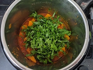 finely shredded spinach added to the squash and chickpea curry