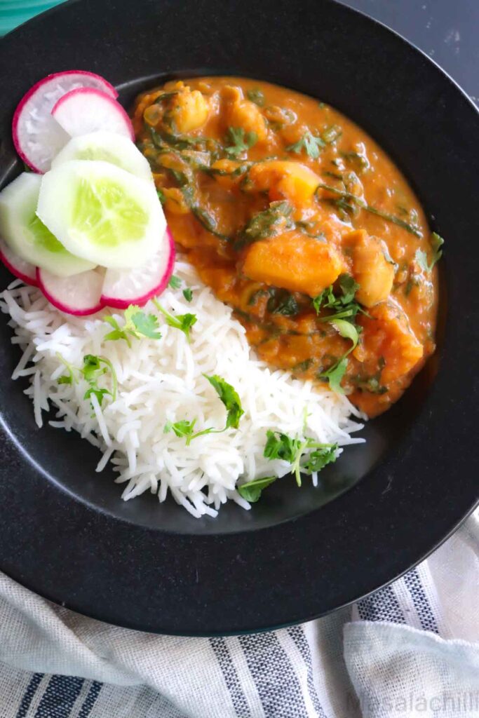 Butternut squash chickpea curry served with basmati rice, sliced cucumbers and radish