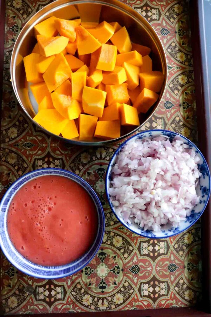 Tray consisting of diced chunks of butternut squash, tomato puree and finely chopped onions