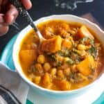 Spoonful of Vegan Butternut Squash Chickpea Curry served in a white bowl