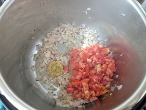 cooking onions, ginger garlic paste and chopped tomatoes for the lentil squash curry