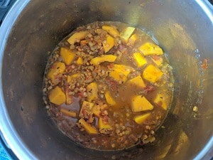process of cooking red lentils, butternut squash in spices
