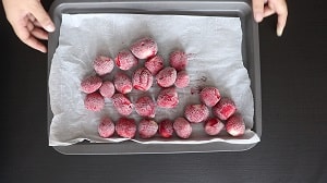 frozen whole strawberries are ready to be packed in freezer safe bags
