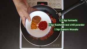 adding spices for saag aloo