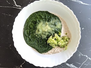 Whole Wheat flour, spinach puree, minced garlic and chili paste with salt for making spinach paratha