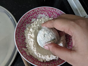 dusting the dough ball with flour
