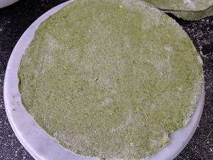 spinach paratha is rolled and ready to be cooked