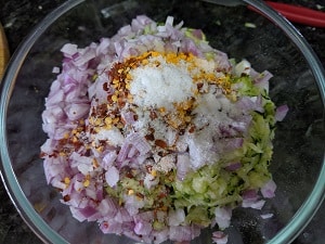 spices and seasoning added to the zucchini fritter batter